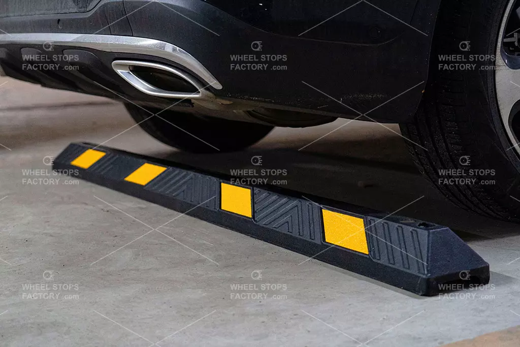 A 1830mm black rubber parking curb with yellow reflective films.