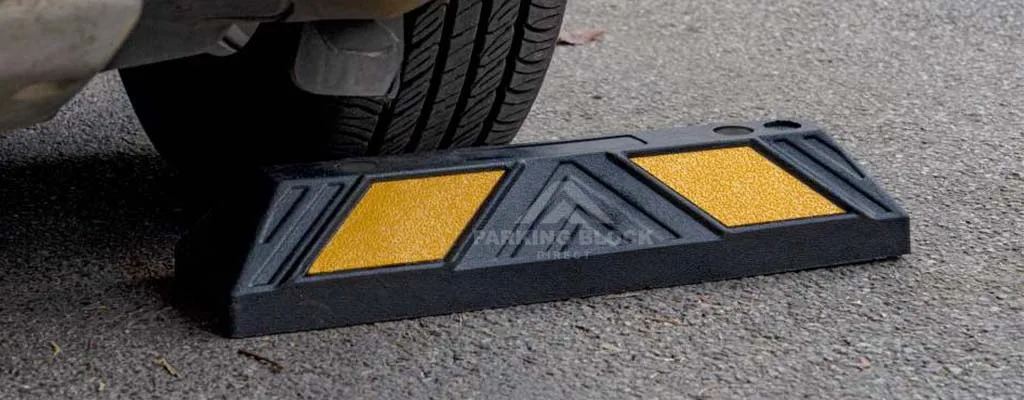 A two feet black parking bumper with yellow reflective films manufactured by Parking Block Direct.