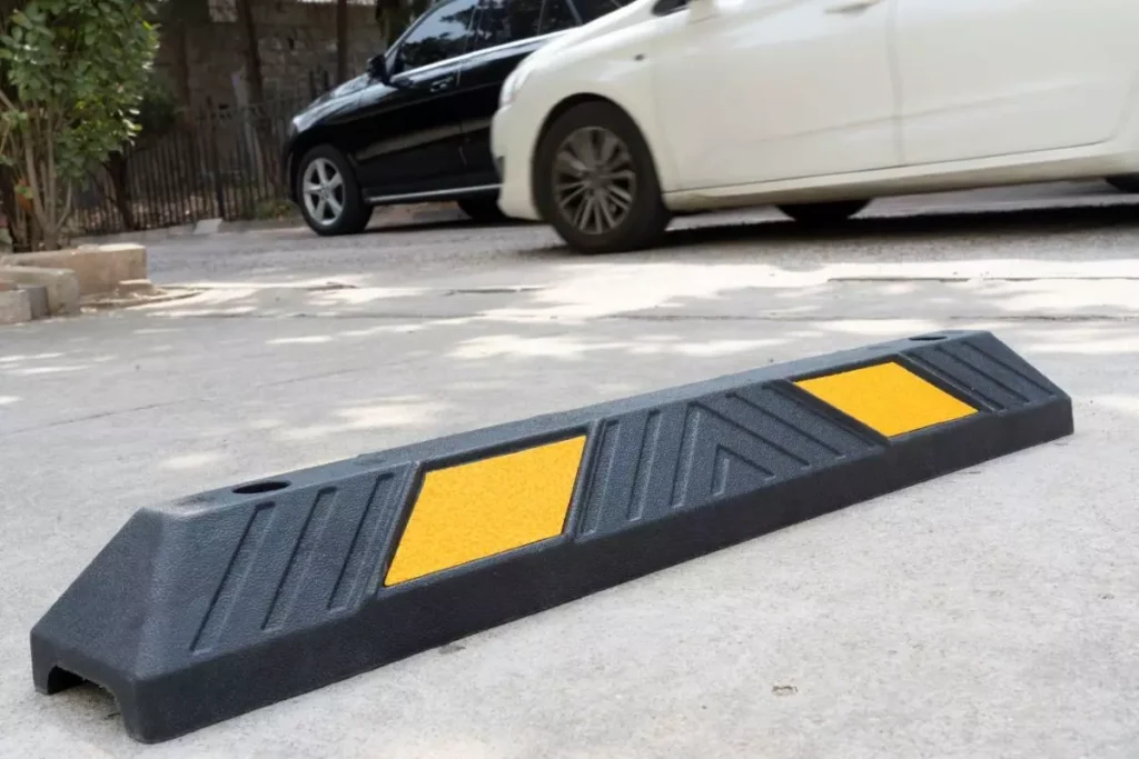 A 900mm parking stop made of plastic and rubber composite placed on the ground