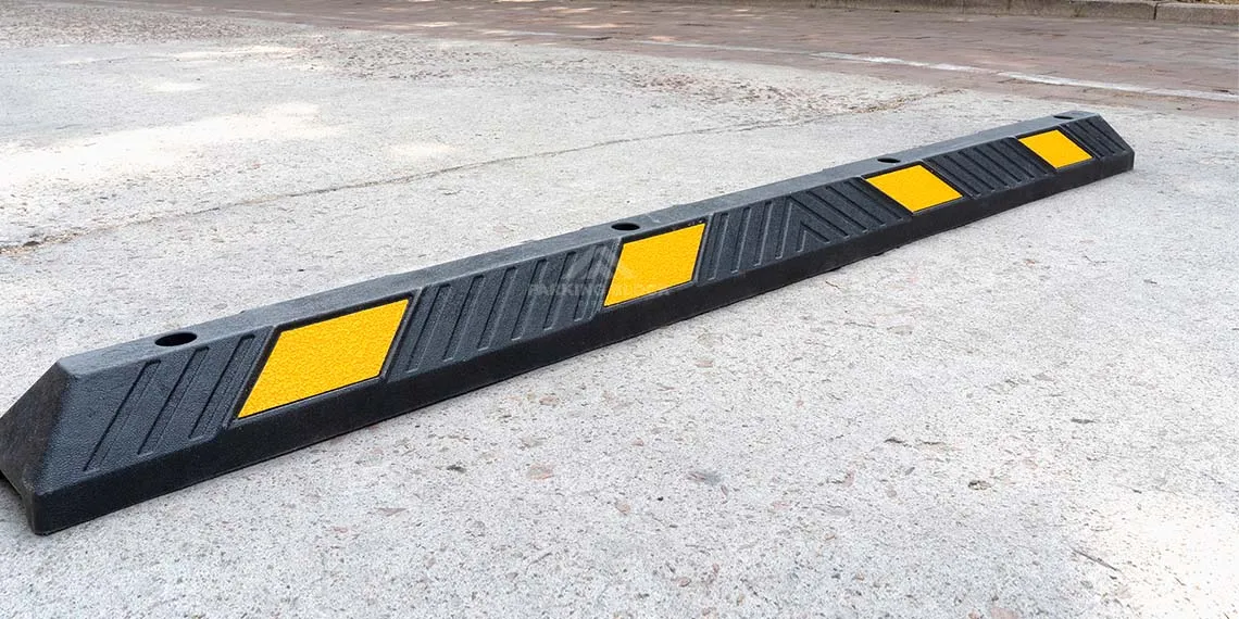 A black car stop with yellow reflective films to help parking.