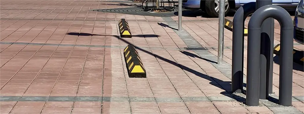 Black and yellow car parking bumpers used to enhance parking safety.