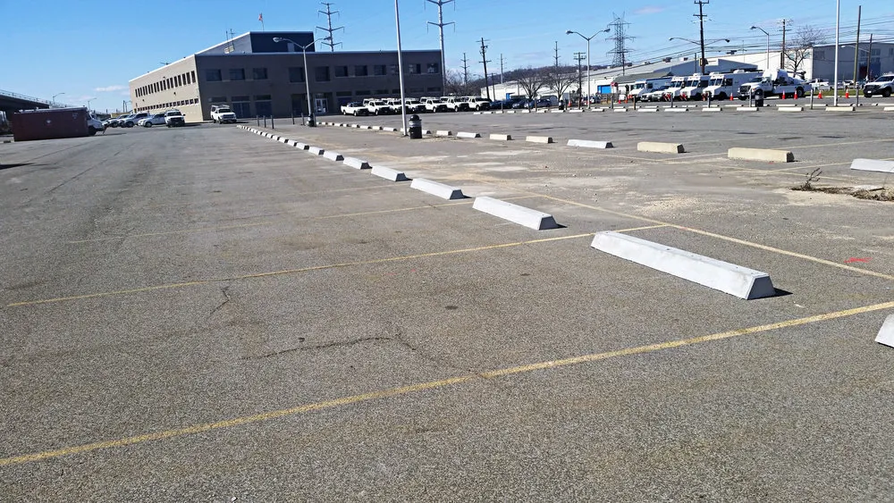 Concrete car park stops in a parking lot to help people parking.