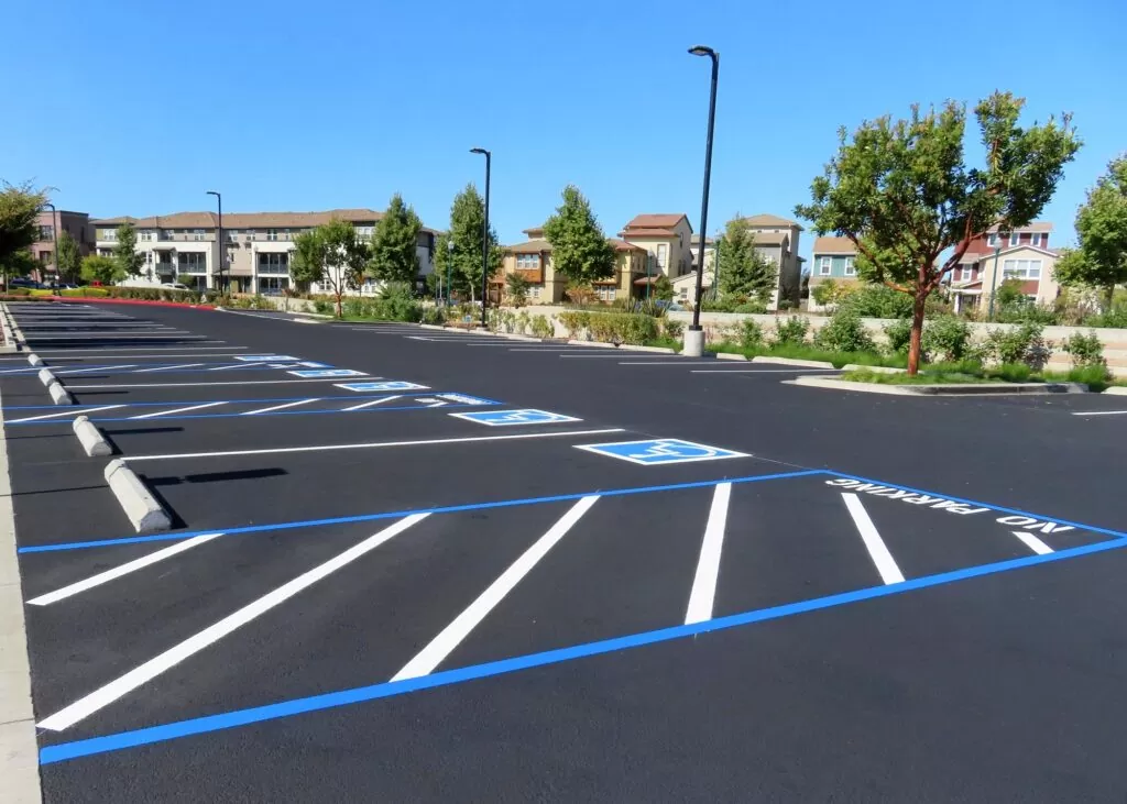 Concrete wheel stops installed in an ADA parking lot to enhance parking safety.