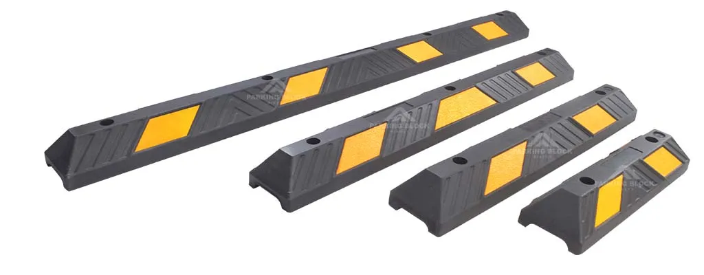 Various black car stops with yellow reflective films manufactured by Parking Block Direct.