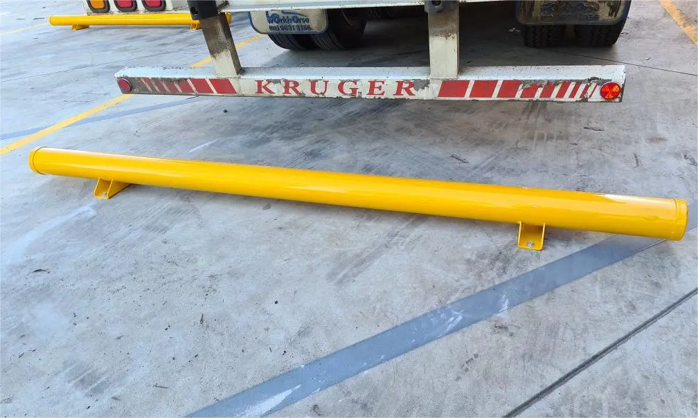 A yellow parking stop made of steel.